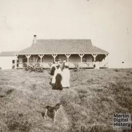 Group of women walking toward one story House of Refuge building