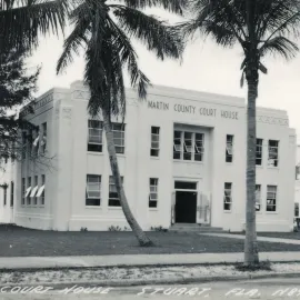Building with signage reading Martin County Court House with two palm trees in front