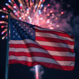 American flag waving in front of fireworks